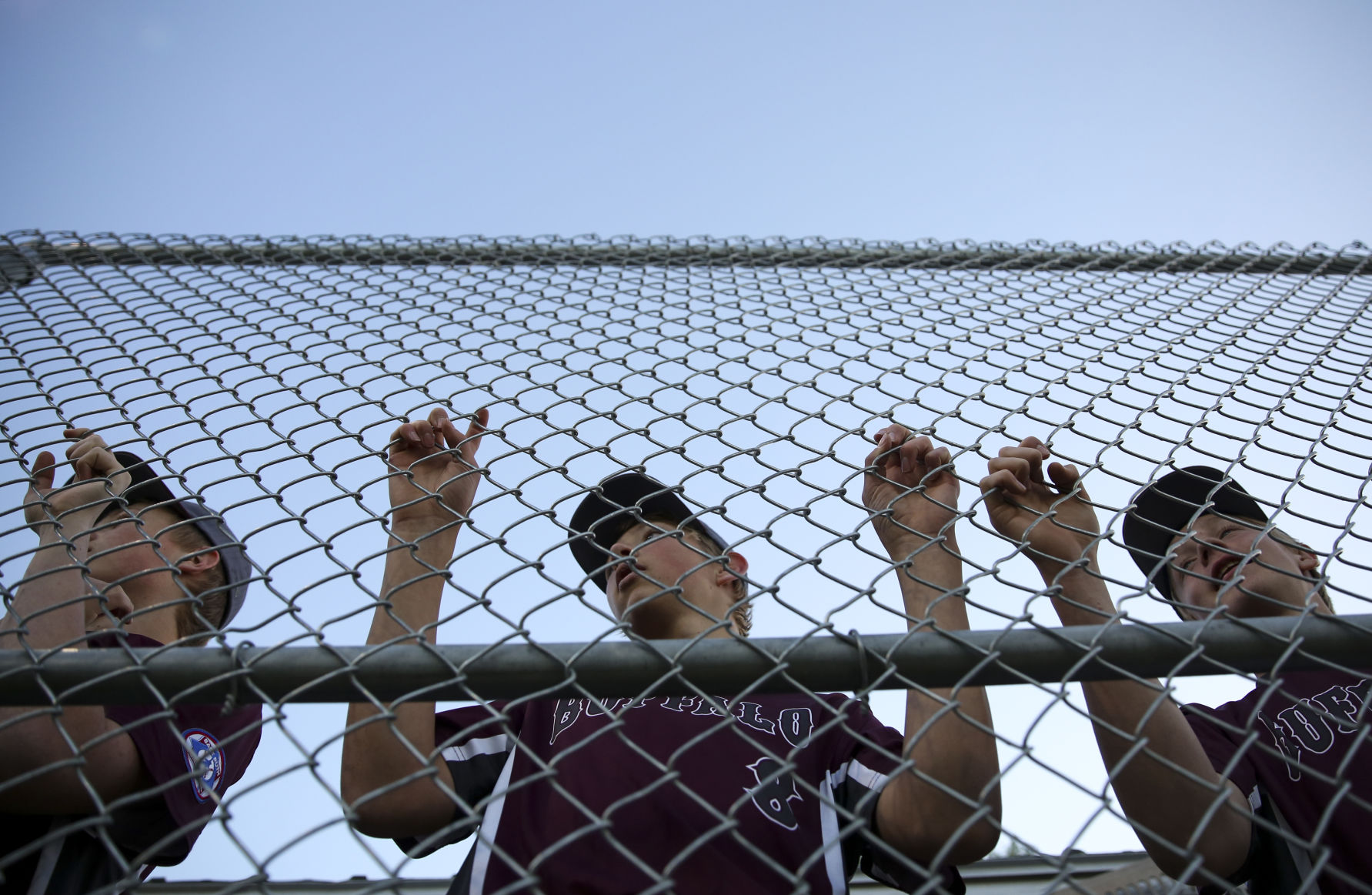 Lane Boden, Brodyn Lambert and Bryce Camino watch the Gillette pitcher warmup